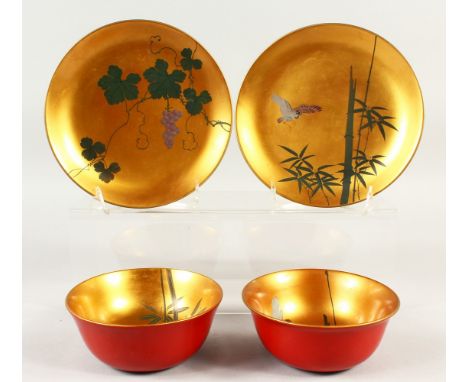 A PAIR OF JAPANESE LATE MEIJI PERIOD LACQUER CUPS &amp; SAUCERS, one cup and saucer depicting sprays of bamboo and grape &amp