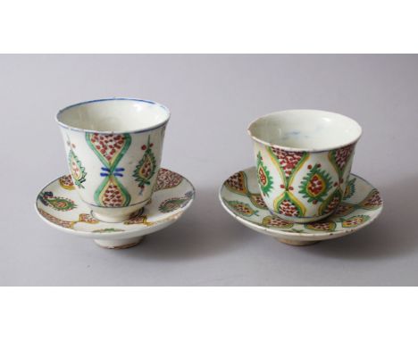 A RARE PAIR OF 18TH CENTURY OTTOMAN TURKISH KUTAHIYA GLAZED POTTERY CUPS AND SAUCERS.