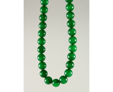 A GOOD CHINESE SPINACH GREEN JADE BEAD NECKLACE, comprising of 74 spherical jade beads, measuring 61cm.