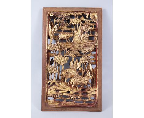 A 19TH CENTURY CHINESE GILT WOOD PANEL, with carved scenes of rams amongst trees and rocks, 39cm  high x 23 cm wide.