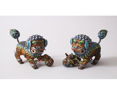 A PAIR OF 19TH / 20TH CENTURY CHINESE SILVER GILT &amp; ENAMEL LION DOG FIGURES, the underside of the paws stamped "silver", 
