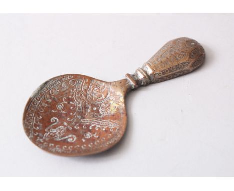 AN EARLY ISLAMIC ENGRAVED BRASS CADDY SPOON, 12cm long.