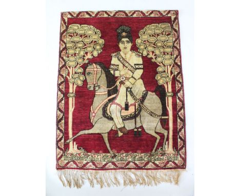 A 19TH CENTURY PERSIAN QATAR LAVAR KIRMAN PORTRAIT RUG, Arnad Sha on horseback, 80cm x 62cm.