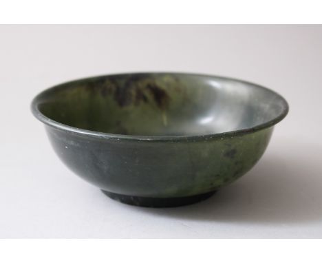 A 19TH / 20TH CENTURY CHINESE SPINACH GREEN JADE BOWL, the base with a chinese script mark, 12.5cm diameter x 4,8cm high.