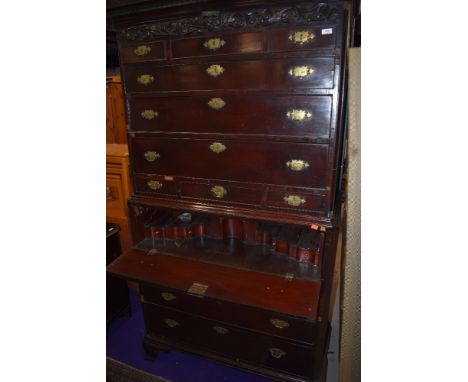 A Georgian mahogany secretaire chest on chest, greek key cornice, possibly later mask decoration, cock beaded drawers with br