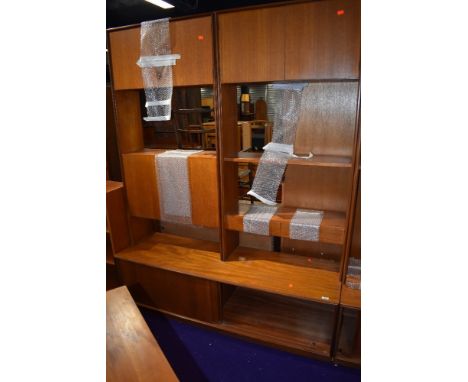 A vintage teak G plan shelf unit having cupboard and cocktail sections with sliding door base, width approx. 153cm