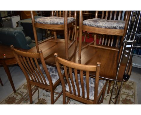 A modern Ercol dining table and six (four plus two) rail back dining chairs, mid colour, in very nice clean condition