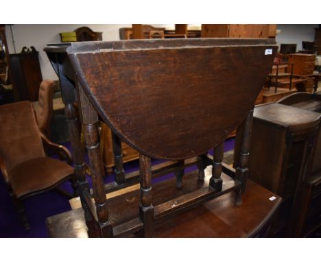 A traditional oak gate leg dining table