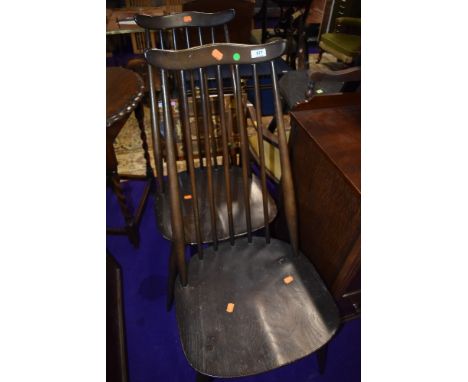 A pair of dark stained Ercol comb and wave back dining chairs