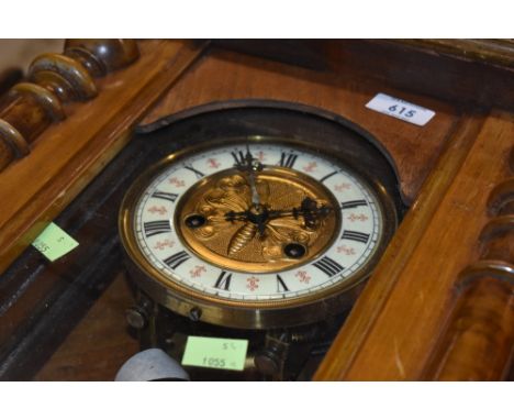 An early 20th Century bleached mahogany Vienna wall clock, having interesting brass butterfly dial , complete with plinth and