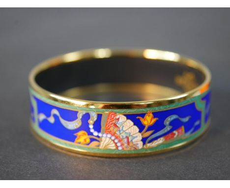 Hermès, a boxed gold plated and enamel Oriental folding fan design bangle with blue ground, makers mark to interior. Diam.6.5