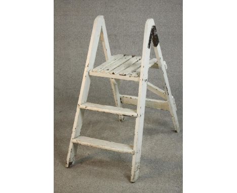 A vintage white painted wooden step ladder, folding and with three steps. H.88 W.35 D.70cm. 