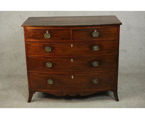 A George III mahogany bow front chest, early 19th century, with two short over three long graduated drawers, over a shaped ap