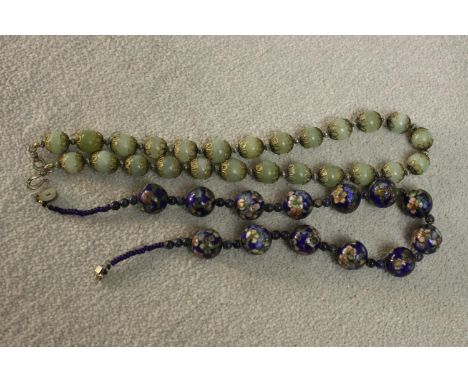 A Chinese cloisonne blue floral enamel design and lapis lazuli bead necklace along with a jade bead necklace with gilt pierce