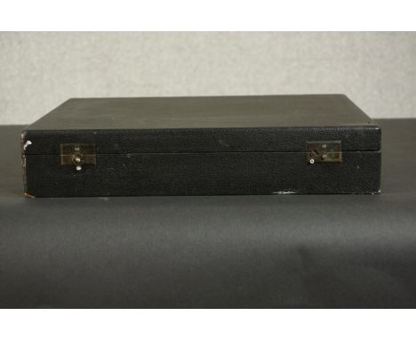 A Harrods black leather cased compendium of board games. Chess, draughts and dominoes and cribbage. H.8 W.39 D.30cm. (Box) 
