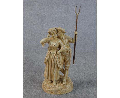 A large Victorian cream glazed ceramic figure group of the haymaker and the milk maid embracing. The haymaker carries a brass