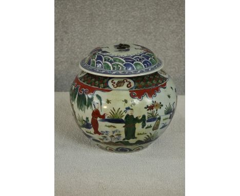 A large early 20th century Chinese hand painted ceramic urn with lid. The urn decorated with a figural design and the lid dec