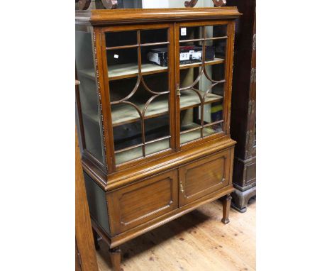 Early 20th Century mahogany cabinet having two glazed panel doors above two cupboard doors on square tapering legs, 145cm by 