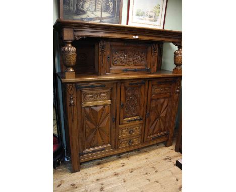 Large carved oak buffet sideboard having four doors and two drawers and carved supports, 176cm by 172cm by 56cm.