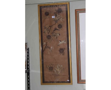Chinese woven silk panel decorated with birds and tree blossom in gilt glazed frame, 94cm by 37cm overall.