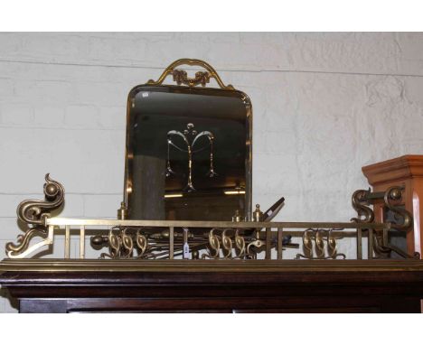 Victorian ornate brass fender, mirrored firescreen, pair of fire dogs and collection of fire irons.