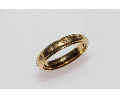 18 carat gold and diamond set band ring, size N.
