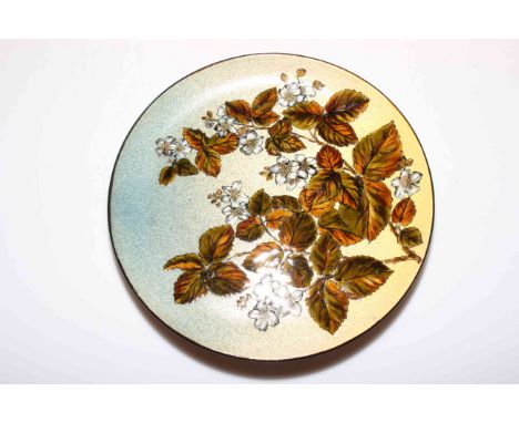 Chr. Dresser Linthorpe pottery plate decorated with overglaze enamel foliage, 29cm diameter.