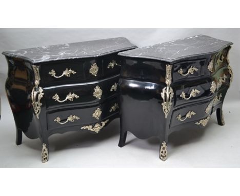 A PAIR OF LOUIS XV STYLE EBONISED COMMODES OF BOMBE FORM with polished veined stone tops, ornate acanthus plated mounts of Ro