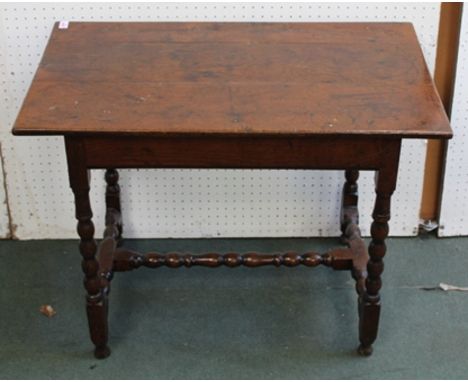 A JACOBEAN DESIGN OAK SIDE TABLE raised on bobbin turned supports with plain stretchers 