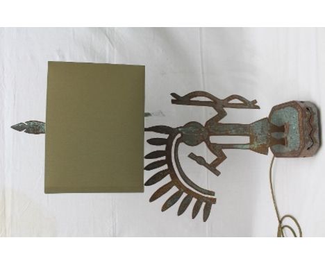 A FIGURAL FRET CUT PATINATED STEEL TABLE LAMP by repute Pozzi Franzetti, the figure standing on a pierced square plinth base 