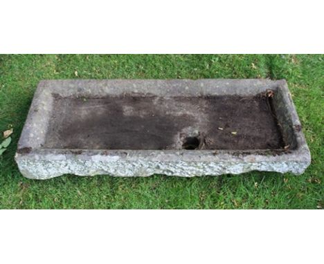 A HAND HEWN BELIEVED LIMESTONE RECTANGULAR SHALLOW SINK/TROUGH with drainage hole 16cm high, 121cm long x 48cm wide 