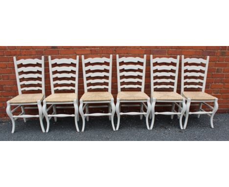 A SET OF SIX PAINTED LADDER BACK SINGLE CHAIRS with woven rush seats by "Sitting Firm" 
