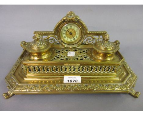 Edwardian brass two bottle ink stand of ornate pierced and relief decorated design, the shaped superstructure inset with a sm