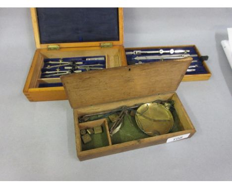 Small mahogany cased set of drawing instruments together with a boxed pair of antique balance scales