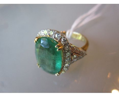 18ct Yellow gold large oval emerald and diamond cluster ring, the emerald approximately 6.90ct