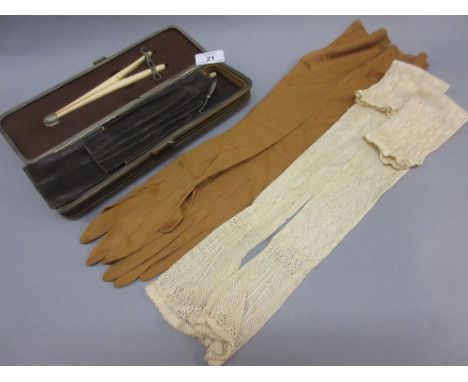 Victorian leather glove case containing various silk and leather gloves, button hook, glove stretchers etc