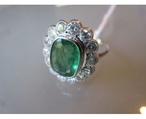 Large emerald and diamond oval cluster ring, the central emerald of approximately 3ct surrounded by a band of brilliant cut d