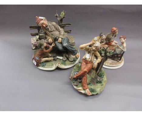 Large Capo di Monte group of an old man sitting on a bench, a boy at his side, signed Milio, together with a similar smaller 