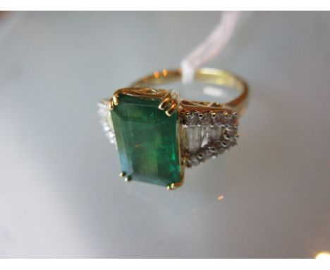 18ct Emerald and diamond cluster ring, the emerald approximately 3.20ct