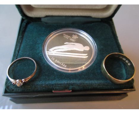 18ct Gold wedding band, a small ring (at fault) and a boxed Canadian Olympic twenty dollar coin