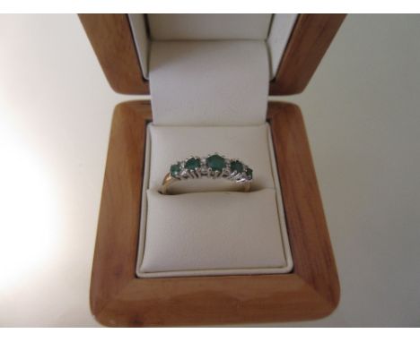 9ct Yellow gold five stone emerald and diamond chip set ring in wooden ring box