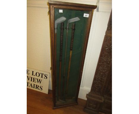 Group of four vintage golf putters in an oak display case, together with a collection of other various hickory shafted golf c