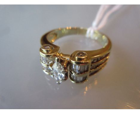 14ct Yellow gold ring with scroll shoulders set central marquise cut diamond and baguette cut diamonds