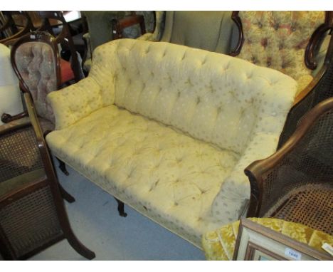 Edwardian two seat yellow button upholstered sofa on shaped front supports with brass casters CONDITION REPORT Upholstery  ne