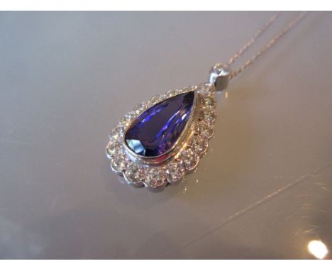 Large tanzanite and diamond pendant, the central pear shaped tanzanite of approximately 5.4ct surrounded by a band of brillia