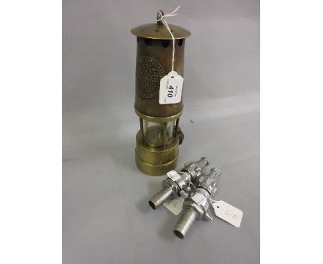 Protector Lamp and Lighting Company miner's lamp and a pair of chrome plated hose nozzles