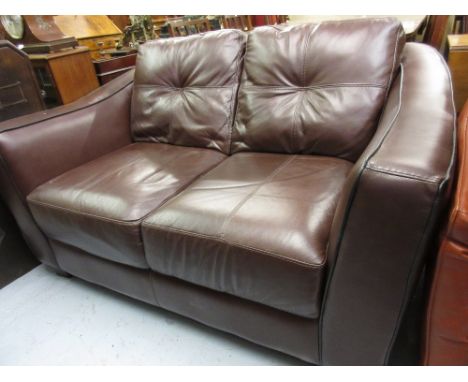 Modern brown leather upholstered two seat sofa, together with a matching footstool