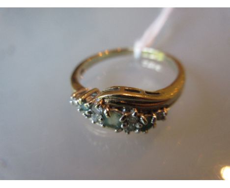 9ct Yellow gold three stone emerald and diamond chip ring