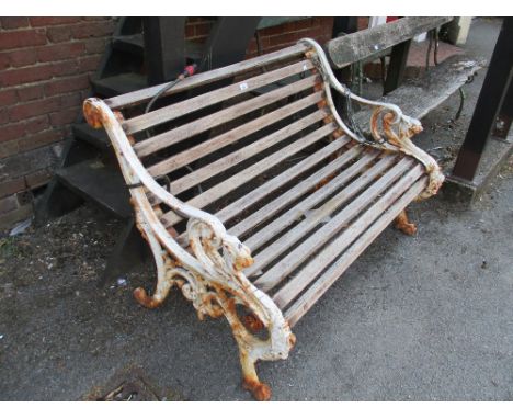 19th Century white painted cast iron and wooden slatted garden bench, the front supports in the form of gryphons on paw feet,