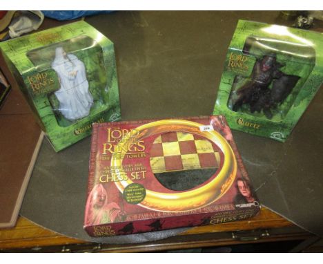Lord of the Rings composite chess set together with two boxed Lord of the Ring figures